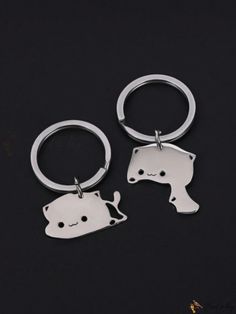 two metal key chains with cats on them