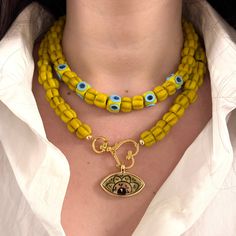 This exquisite double layer necklace features a beautiful combination of artisan-made glass beads and handcrafted ceramic evil eye pendants, creating a unique and eye-catching design. One layer includes elegant glass cube evil eye beads, while the other showcases a stunning ceramic evil eye pendant set in a 24kt gold plated bezel. Both layers are adjustable with two-inch extender chains, making it easy to find the perfect length for your style. Wear them together for a layered look or separately Ceramic Evil Eye, Glass Evil Eye, Evil Eye Beads, Double Layer Necklace, Talisman Necklace, Glass Cube, Layer Necklace, Eye Beads, Eye Pendant