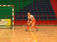 two women are playing tennis in an indoor court