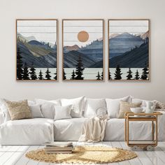 two paintings hanging on the wall above a white couch in a living room with a coffee table