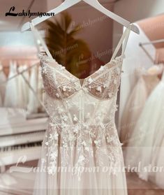 wedding dress on display in front of mirror