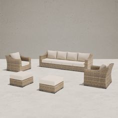 a set of wicker furniture sitting on top of a cement floor