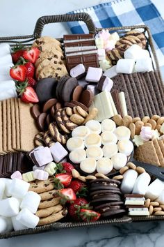 a basket filled with lots of different types of desserts and marshmallows