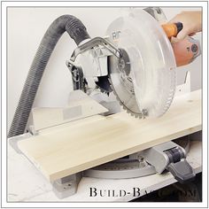 a person using a circular saw to cut wood