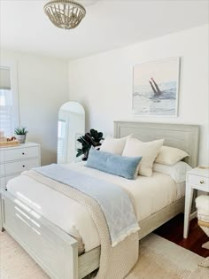 a bedroom with a bed, dressers and pictures on the wall above it's headboard