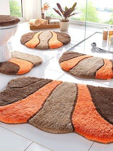 bathroom rugs with orange and brown designs on the floor