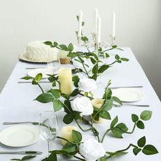 the table is set with white flowers and candles