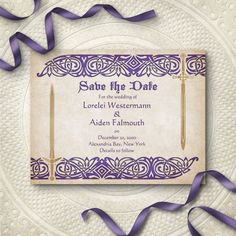 an ornate save the date card with purple ribbons and ribbon streamers on top of it