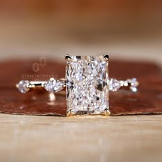 a diamond ring sitting on top of a wooden table