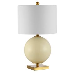 a table lamp with a white shade on the base and a gold plated base