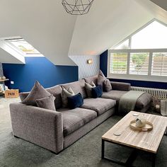 a living room filled with furniture and a skylight in the ceiling above it's windows