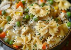 a bowl filled with pasta and peas on top of a table