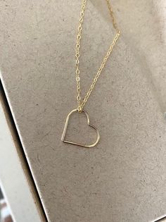 This simple, dainty 14k gold filled floating open heart necklace can be customized to your preferred length.  It's simply suspended from delicate 14k gold filled chain finished with a lobster claw clasp.  The heart is a great size, not too small and not too big at 17.5mm.  A wonderful handmade jewelry gift for bridesmaids, best friend, anniversary or a special woman on any occasion! You may also like to check out more of my necklaces here: http://etsy.me/2kMdyB0 Free first class USPS shipping wi Minimalist 14k Gold Filled Open Heart Jewelry, Everyday 14k Gold Open Heart Charm Necklace, Simple Gold Charm Necklace For Valentine's Day, Delicate 14k Gold Filled Heart Necklace For Valentine's Day, Simple Gold Necklaces For Valentine's Day, Delicate 14k Gold Filled Heart Necklace For Everyday, Minimalist 14k Gold Filled Heart Pendant Necklace, Delicate 14k Gold Open Heart Charm Necklace, Minimalist Open Heart Charm Necklaces For Mother's Day