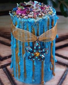 a blue cake with chocolate and sprinkles on it sitting on a table