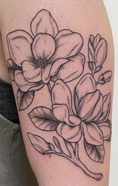 a black and white flower tattoo on the arm