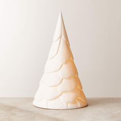 a white ceramic christmas tree sitting on top of a table