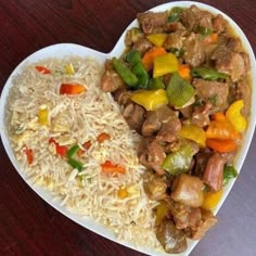 a heart shaped plate filled with rice and meat