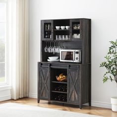 a microwave oven sitting on top of a wooden cabinet