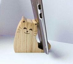 an image of a wooden phone holder with a cat design on the front and side