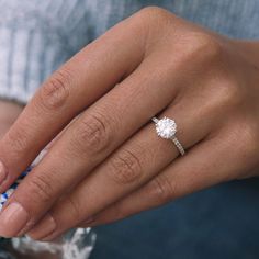 a woman's hand with a diamond ring on it