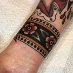 a close up of a person's foot with a tattoo on it and flowers