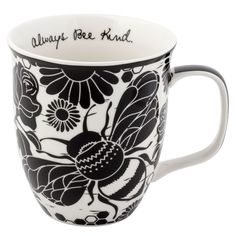 a black and white coffee cup with flowers on it