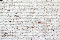 an old brick wall and wooden floor in front of it