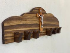 a wooden cross mounted to the side of a wall