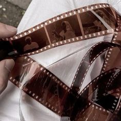 a person holding a film strip with pictures on it