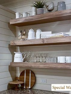 the shelves in the kitchen are filled with dishes and cups, along with other items