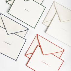 four envelopes with different colors and designs on the front, one in red, one in white