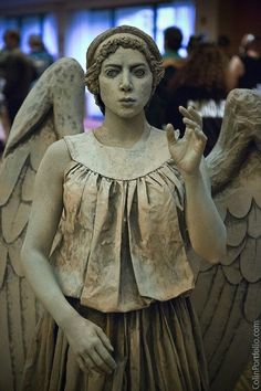 a statue of an angel with outstretched hands