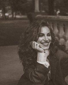 a black and white photo of a smiling woman