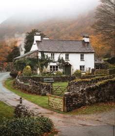 an image of a house in the middle of the road with fog coming from behind it