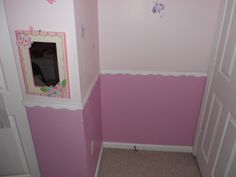 a bathroom with pink walls and white trim