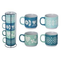 four mugs and a rack are shown in this image, one has blue flowers on it