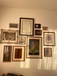 there are many framed pictures on the wall