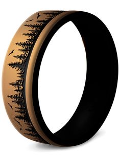 a black and gold ring with trees on it