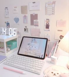 an open laptop computer sitting on top of a white desk