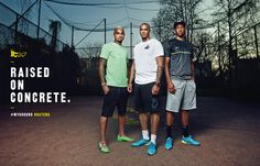 three men standing next to each other in front of a tennis net with the caption raised on concrete