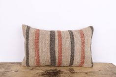 a striped pillow sitting on top of a wooden table