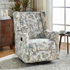 a living room with a chair and rug in front of a window, next to a coffee table