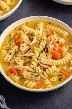 two bowls filled with chicken noodle soup