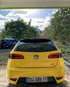 the rear end of a yellow sports car