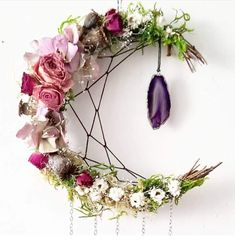 a wreath with flowers and an amethorate hanging from it