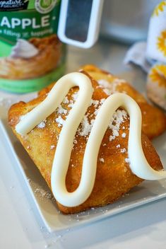 two pastries with white icing on a plate