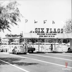 an old black and white photo of a six flags sign in front of a gas station