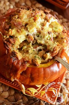 a pumpkin filled with stuffing sitting on top of a table