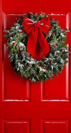 a red door with a wreath on it