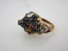 "A lovely vintage 18k gold and multi stone ring, featuring mainly sapphires. The style is known as a Thai Princess ring, with it's gemstone studded pointy top. Marked \"18k\". US size 5.5 and is resizable at any jeweler. Actual packaging will vary depending on item/s purchased and tape pattern available. Props shown in photos is for display purposes only, not included in this listing. As always, satisfaction is guaranteed. Thanks for shopping Vintage In Bloom More rings: http://www.etsy.com/shop Tape Pattern, Princess Ring, Gemstone Studs, Multi Stone Ring, Multi Stone, Rings For Women, Ring Gold, In Bloom, Stone Ring